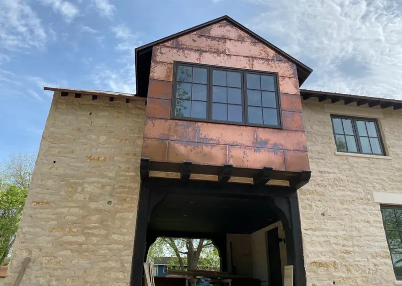 Copper metal panel facade on a stone building for Roof Repair in Green Brook