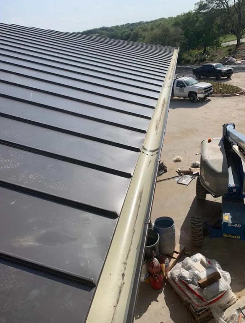 Standing seam panel and gutter detail on a metal roofing jobsite in Green Brook